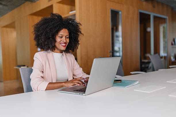 istock Smiling woman working on laptop in bright office 2226793833