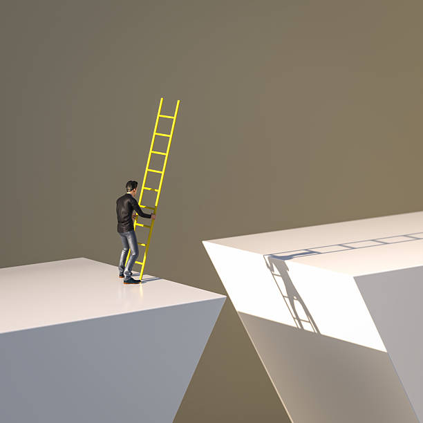 istock A man standing at a gap and trying to bridge it with  a ladder. Concept for taking risks, courage, the way forward, finding solutions. 2226793890