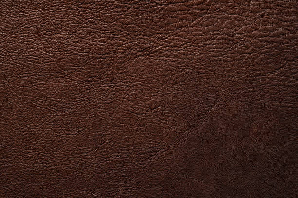 istock dark leather background. brown skin texture with natural pattern 2226794369