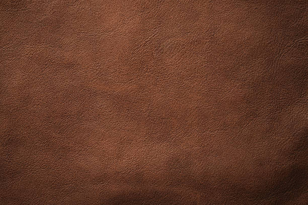 istock brown leather texture, skin surface as dark background 2226794467