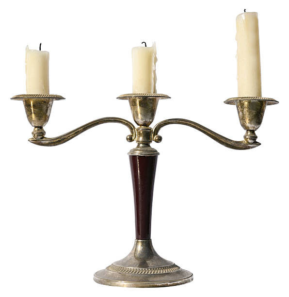 istock Antique brass candlestick with three candles isolated on a white background. Full depth of field. 2226794918