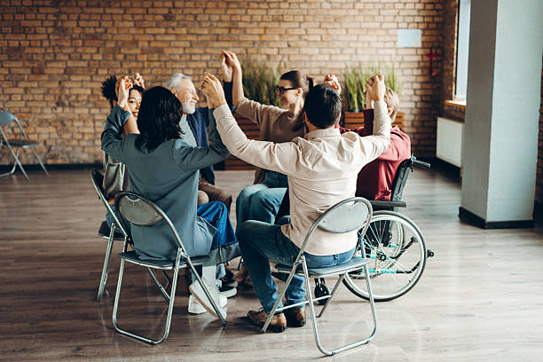 istock Diverse multinational group holding hands together sitting in modern office 2226795539