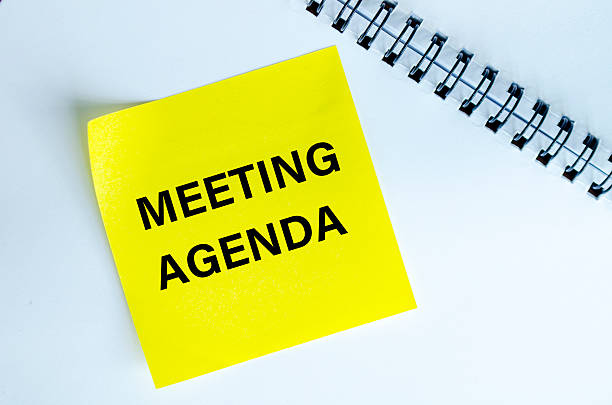 istock Meeting Agenda text on yellow notepad. Meeting agenda concept 2226796575
