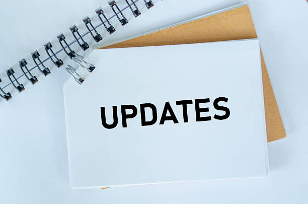 istock Top view of Updates text on white notepad. Business update concept 2226796576