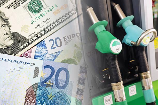 fuel prices and global currencies. gas station nozzles and international money. economic inflation and energy cost concept. - akaryakıt fiyatları stok fotoğraflar ve resimler