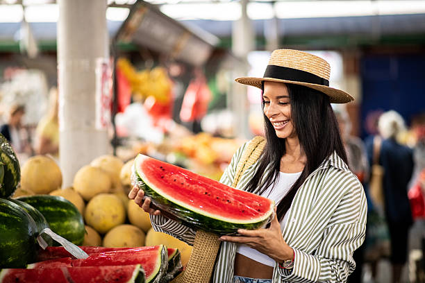 istock Beautiful woman smiling with watermelon slice 2226797722