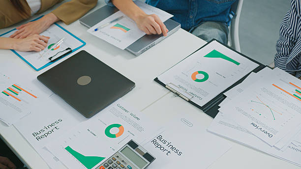 istock Business analysis captured through vibrant pie charts bar graphs on a document Financial Documents report marketing startup goals investment strategy saving performance teamwork management 2226797845