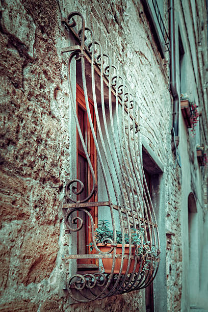 Charming Mediterranean Window with Ornate Ironwork in Tuscany