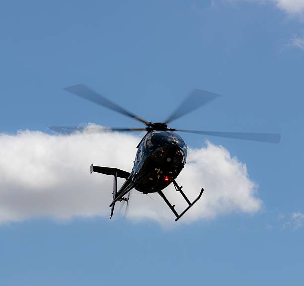istock Helicopter soaring in the blue sky. 2226798923