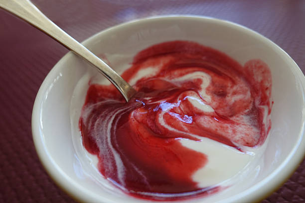 White cheese served as a dessert with a red fruit coulis