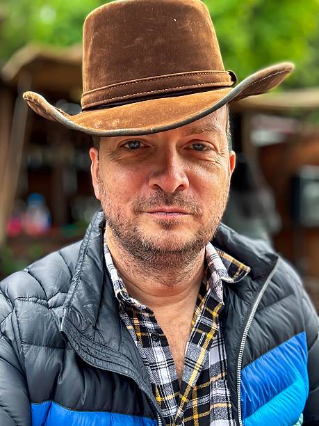 A middle aged man wearing a cowboy hat at a ranch outside of Mexico City, Mexico