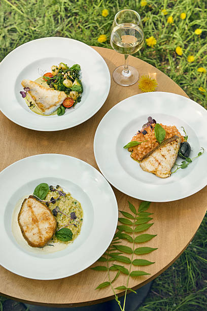 istock Halibut, zander, cod plates in bright outdoor overhead, round table summer composition 2226806712