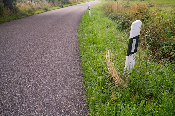 istock Roadside reflector post marking a curve on a country road 2226807934