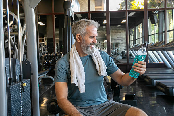 istock Smiling Elderly Man With Towel and Water Bottle at Gym 2226813077