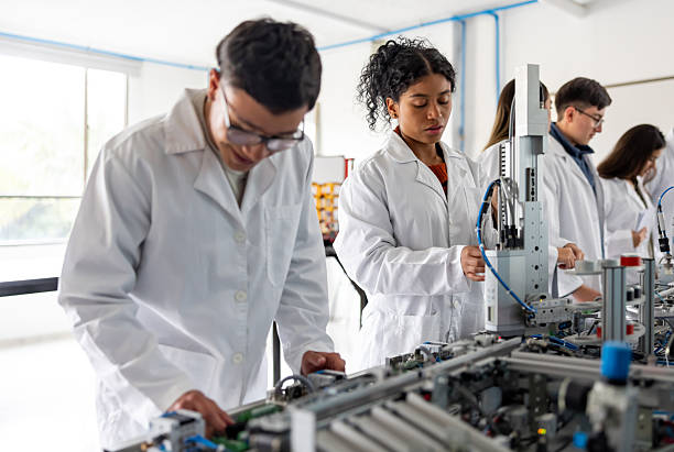 istock Robotic students building a production line robot in a STEM class 2226813135