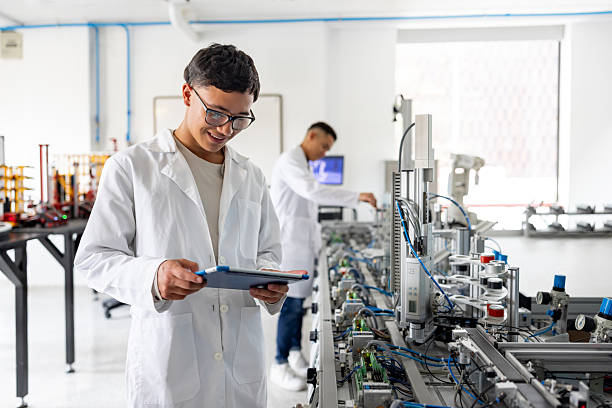 istock Student holding a tablet while supervising the operation of a production line robot 2226813162