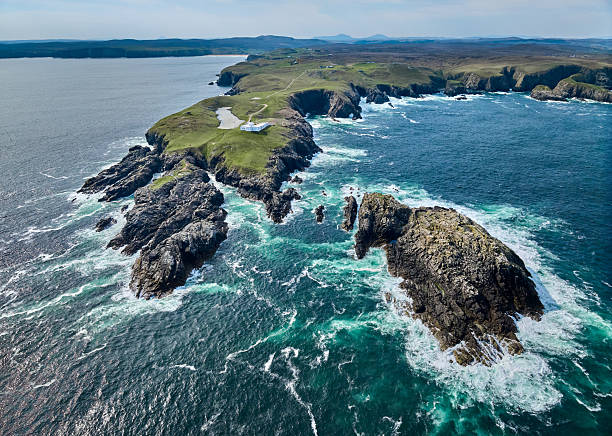 istock Strathy Point lighthouse with surf on the cliff, Scotland 2226814943