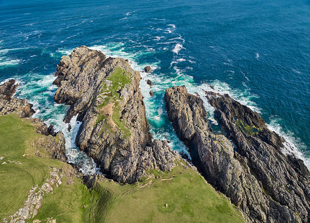 istock heavy surf on rocky cliffs in Scotland, UK 2226816726