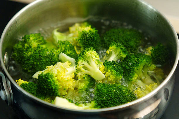 istock Cooking fresh broccoli in a saucepan over medium heat during a sunny afternoon 2226818911