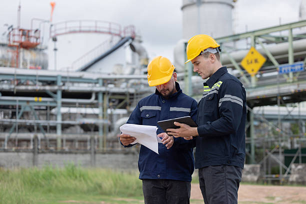 istock Petroleum engineers working at oil refinery site 2226819423