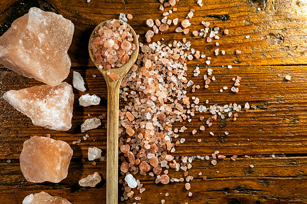 istock Himalayan salt - large and medium size pieces on a table with wooden spun 2226819723