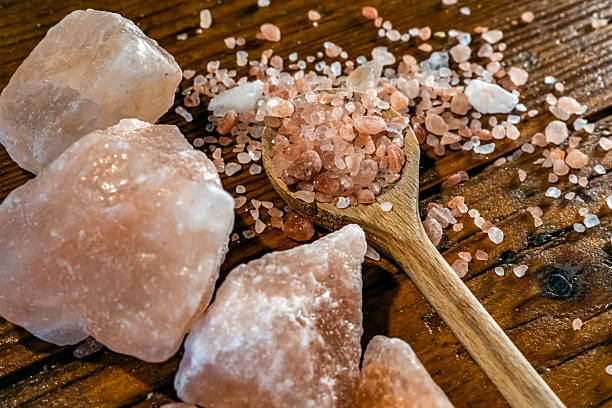 istock Himalayan salt - large and medium size pieces on a table with wooden spun 2226819726