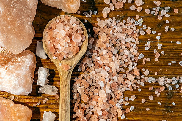 istock Himalayan salt - large and medium size pieces on a table with wooden spun 2226819737