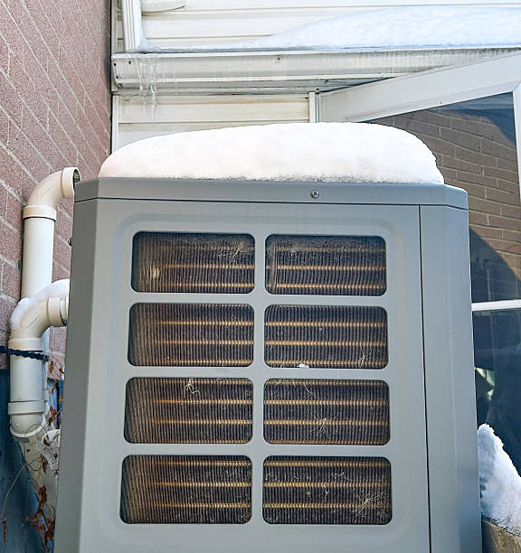 istock Snow-Covered HVAC Unit Outside Home 2226821185