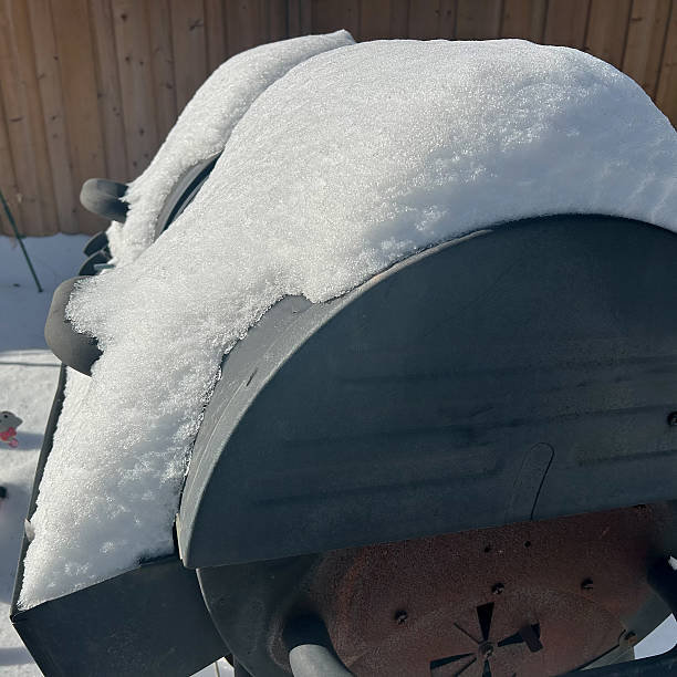 istock Snow-Covered Outdoor Grills In A Winter Backyard 2226821325