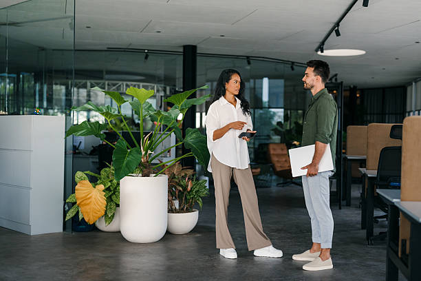 istock Two happy diverse multiethnic business team people working, talking in corporate office 2226824001