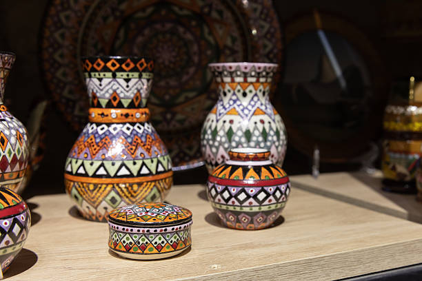 istock Colorful Handcrafted Pottery With Intricate Patterns Displayed on a Wooden Shelf 2226825979