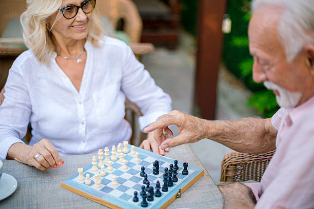 istock Senior couple playing chess outdoors in retirement 2226828482