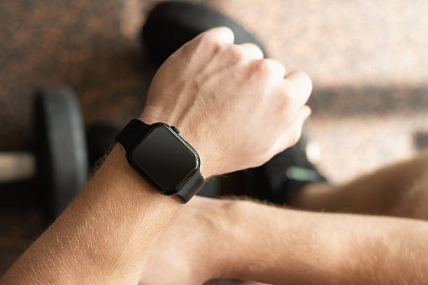 istock Hand with smartwatch set against background at gym. 2226833206