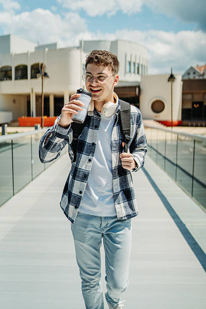 istock Young caucasian man student smiling and using smartphone 2226833332