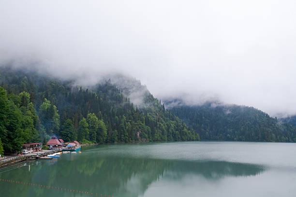 fog above a lake surrounded with mountains