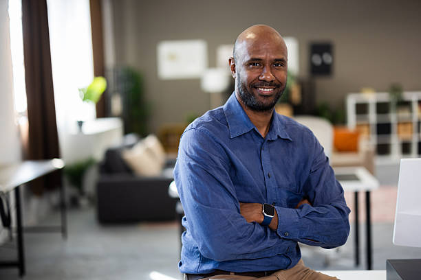 istock Confident businessman smiling with folded arms in modern office 2226835913