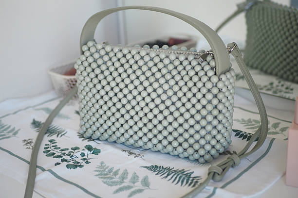 istock Stylish green beaded handbag on a decorative table 2226836349