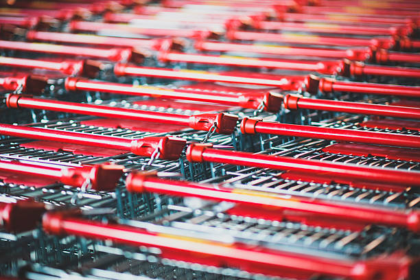 istock Rows of Red Handled Shopping Carts in Bright Retail Store Setting 2226838937
