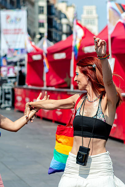 istock Woman dancing with rainbow bag at pride parade celebrating inclusivity 2226839084
