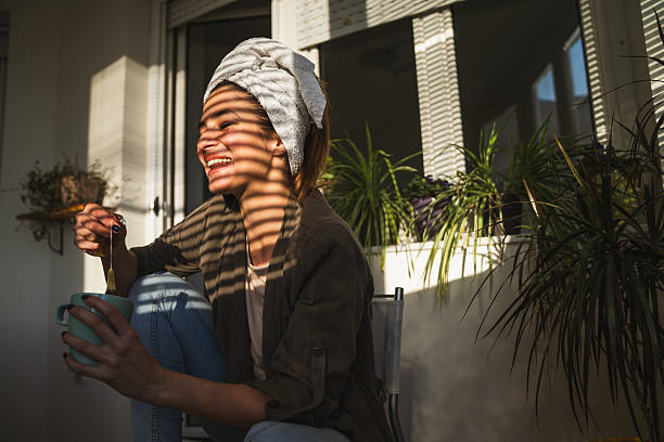 istock Beautiful young woman smiling while pulling tea bag from mug 2226843358