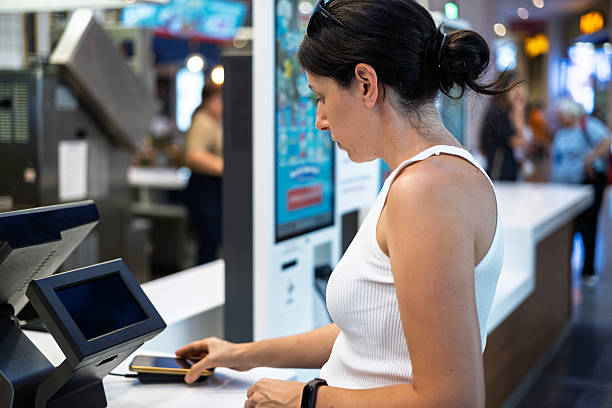 istock Woman Using mobile to pay at Fast Food Restaurant 2226844163