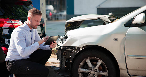 istock Man In White Shirt Inspecting Car After Crash 2226845656
