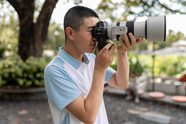 istock An Asian male teenager using a digital camera 2226845849