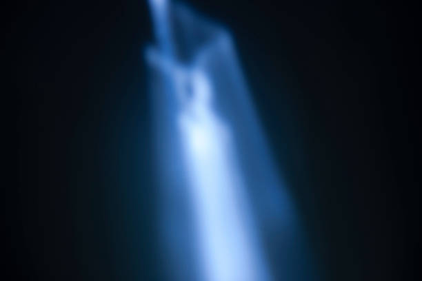 Mystical image showcasing blurred light effects with shades of blue on a dark background, evoking mystery and serenity. This abstract composition creates a sense of depth and motion while highlighting gentle illumination and atmospheric effects. Perfect for backgrounds, artistic designs, and conveying abstract ideas related to light and shadow.