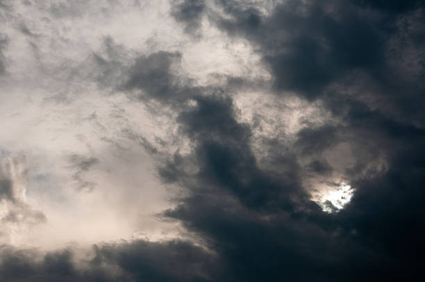 A bright solar disc fights through swirling grey vapor, hinting at volatility and hope in one frame. Ideal for energy, climate change or “light in darkness” themes.