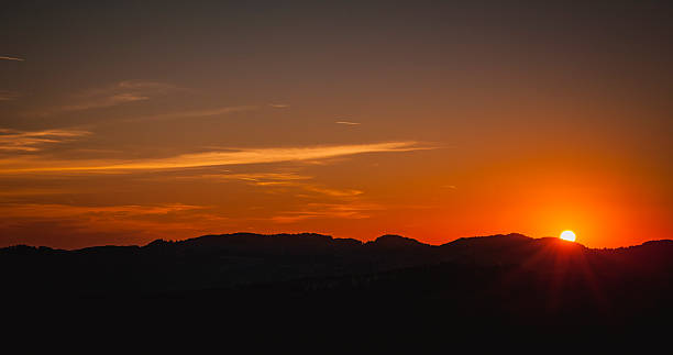 istock Golden Sunset Over Rolling Hills with Fiery Orange Sky 2226847755