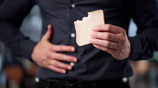 istock Young Man Grimaces In Pain After Eating Forbidden White Bread 2226849020