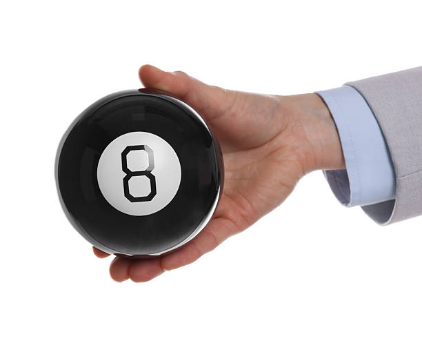 istock Man holding magic eight ball on white background, closeup 2226850491