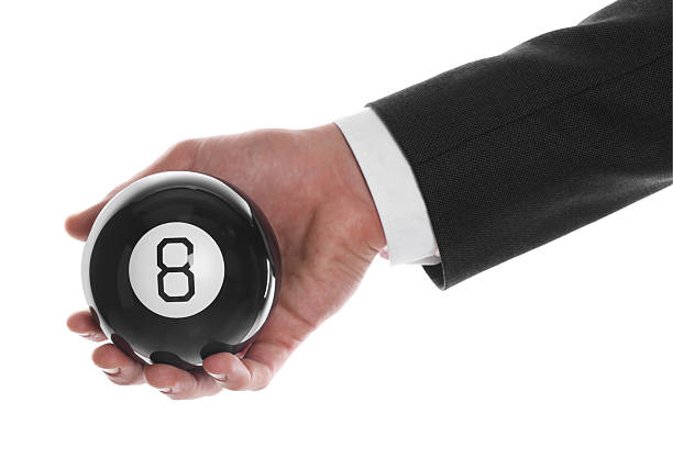 istock Man holding magic eight ball on white background, closeup 2226850539