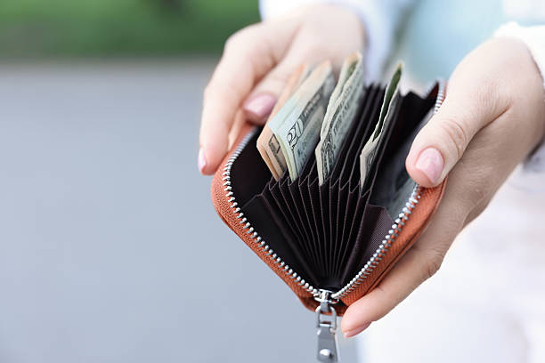 istock Woman holding purse with banknotes outdoors, closeup. Space for text 2226850640